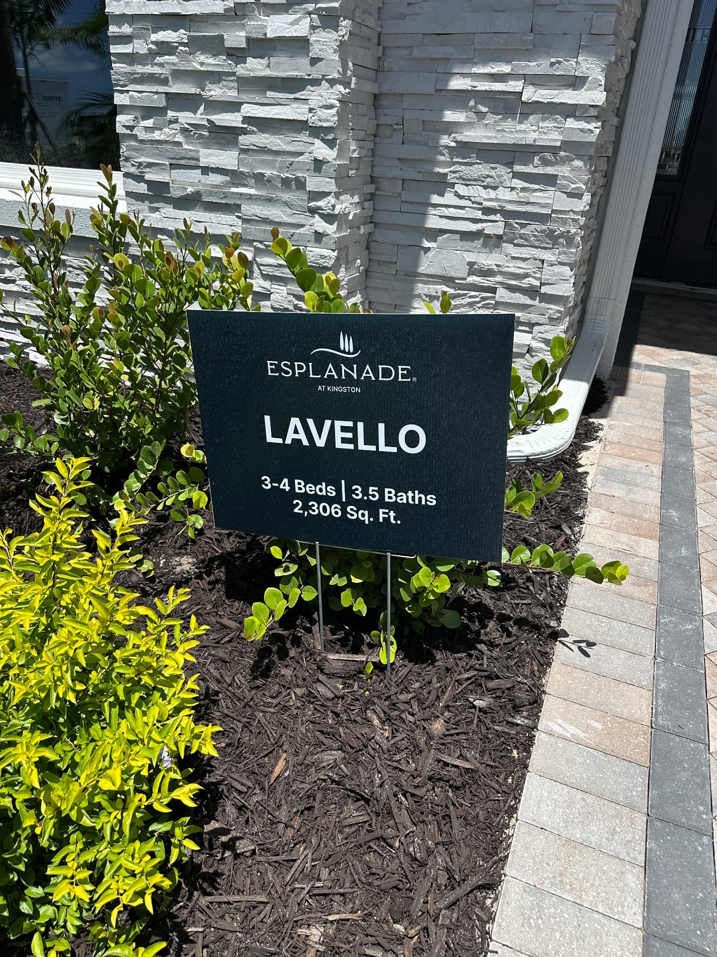 Esplanade at Kingston Lavello model home sign in Estero, FL listing 3 to 4 beds, 3.5 baths and 2,306 sq ft, photographed August 2026