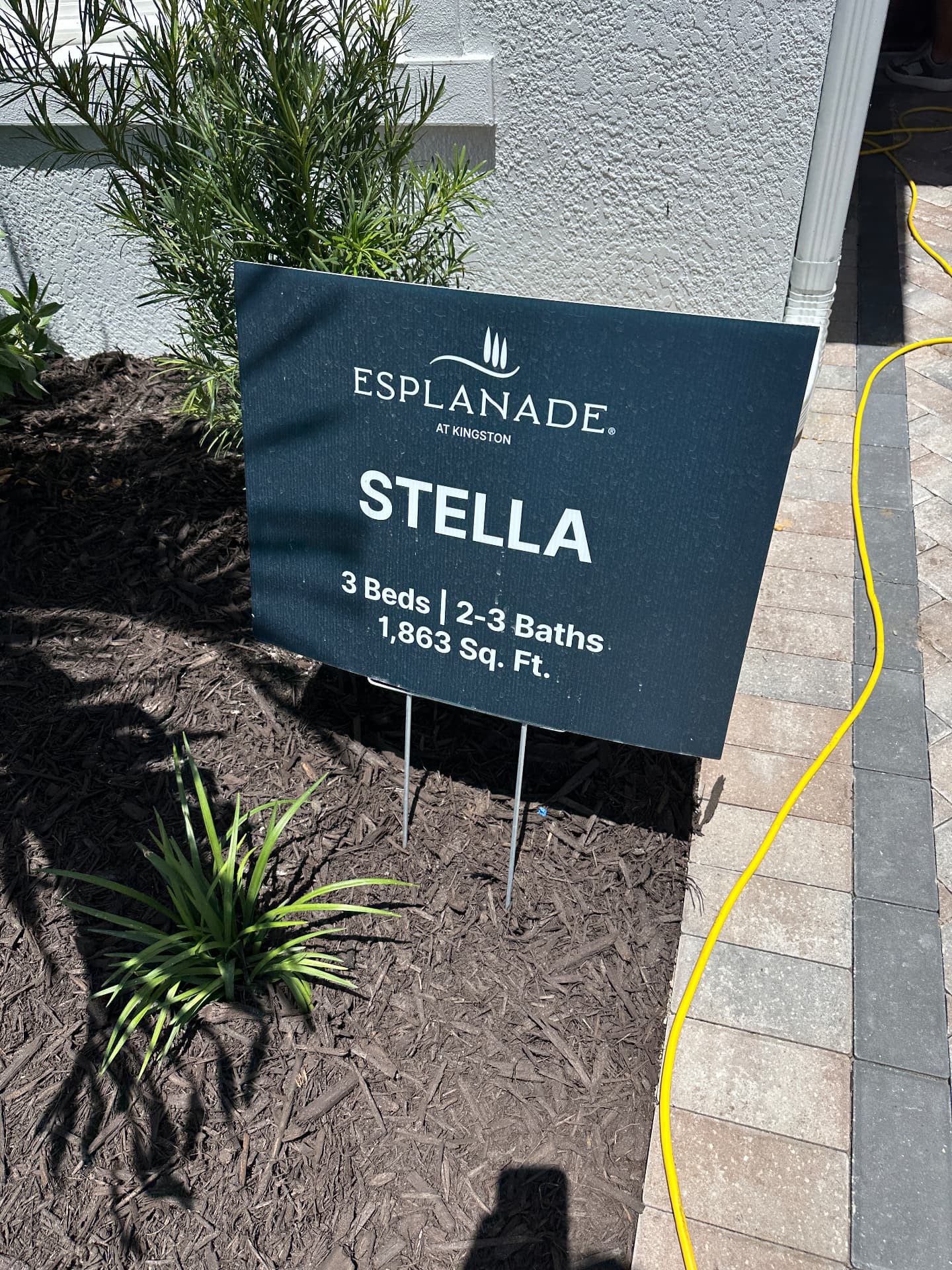 Esplanade at Kingston Stella model home sign in Estero, FL listing 3 beds, 2 to 3 baths and 1,863 sq ft, photographed August 2026