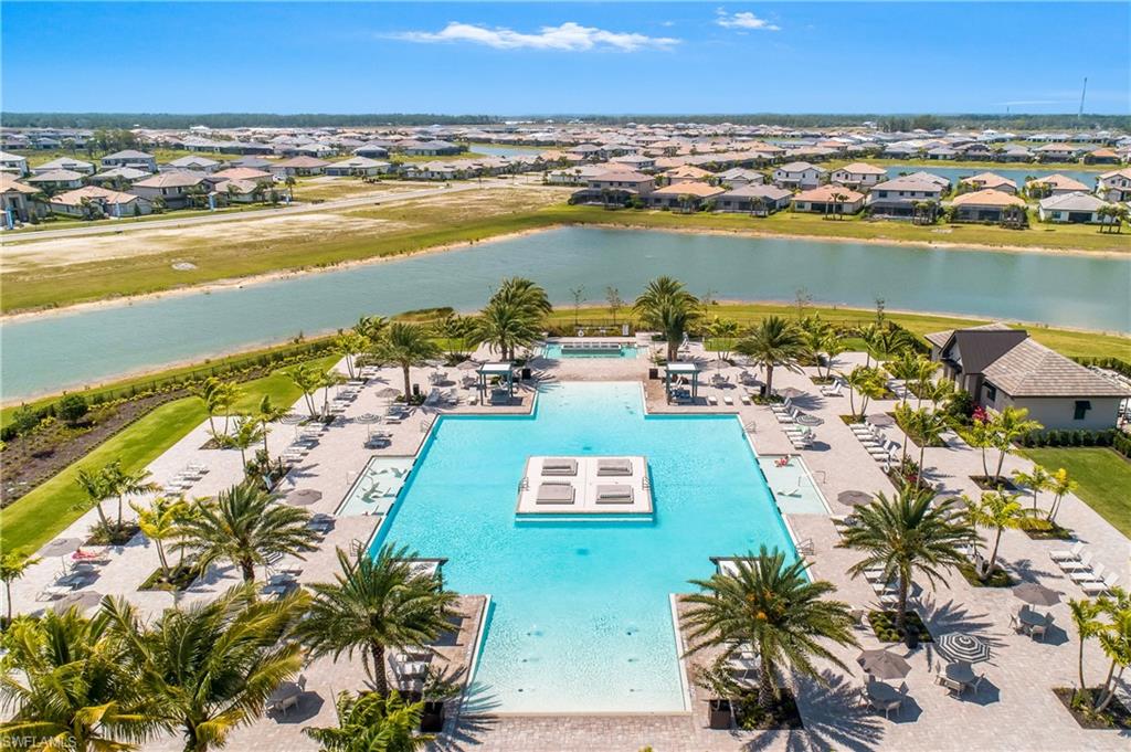 Aerial view of Verdana Village resort pool and lakefront community in Estero, Florida